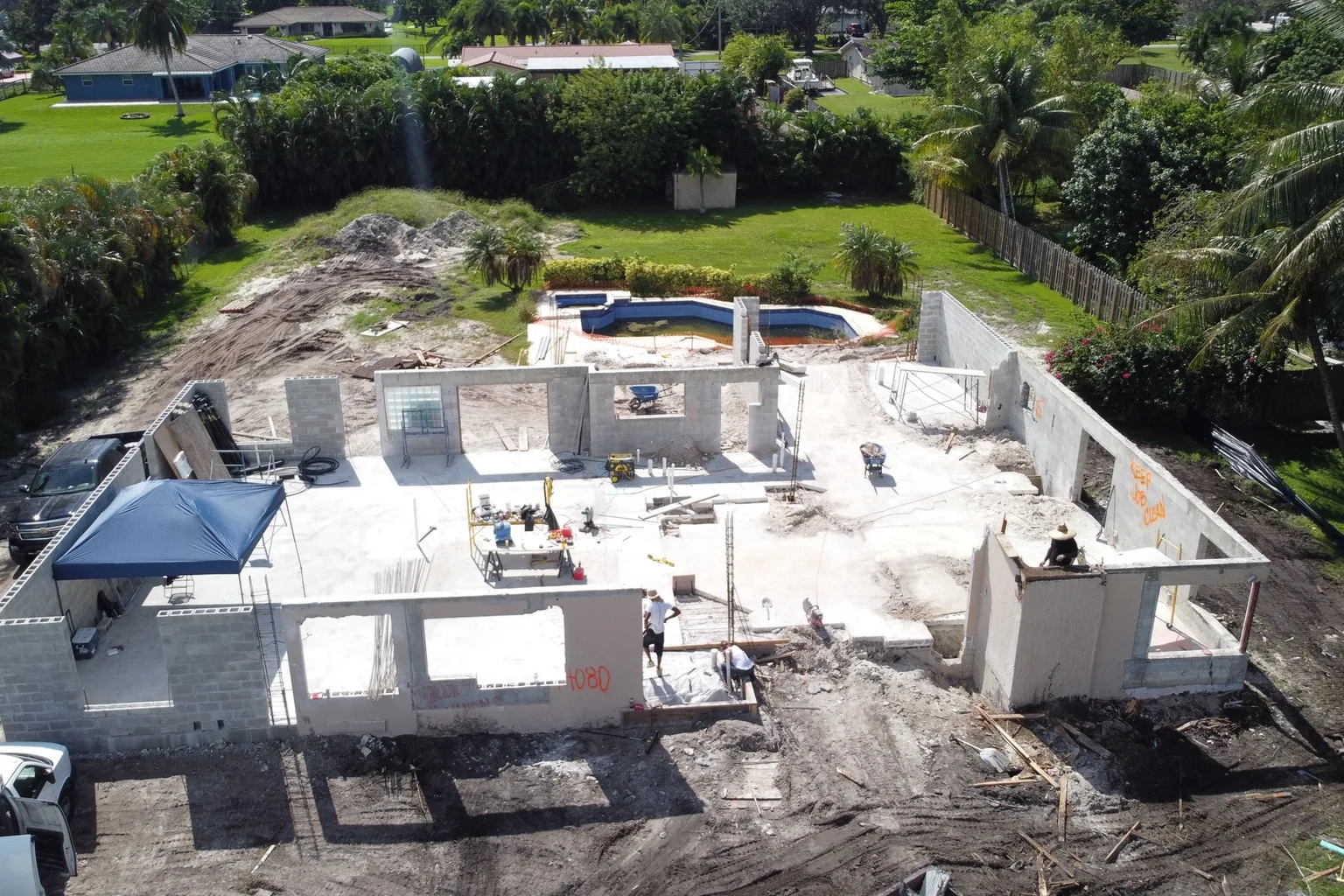 Aerial view of a house slab poured with the first block walls laid out