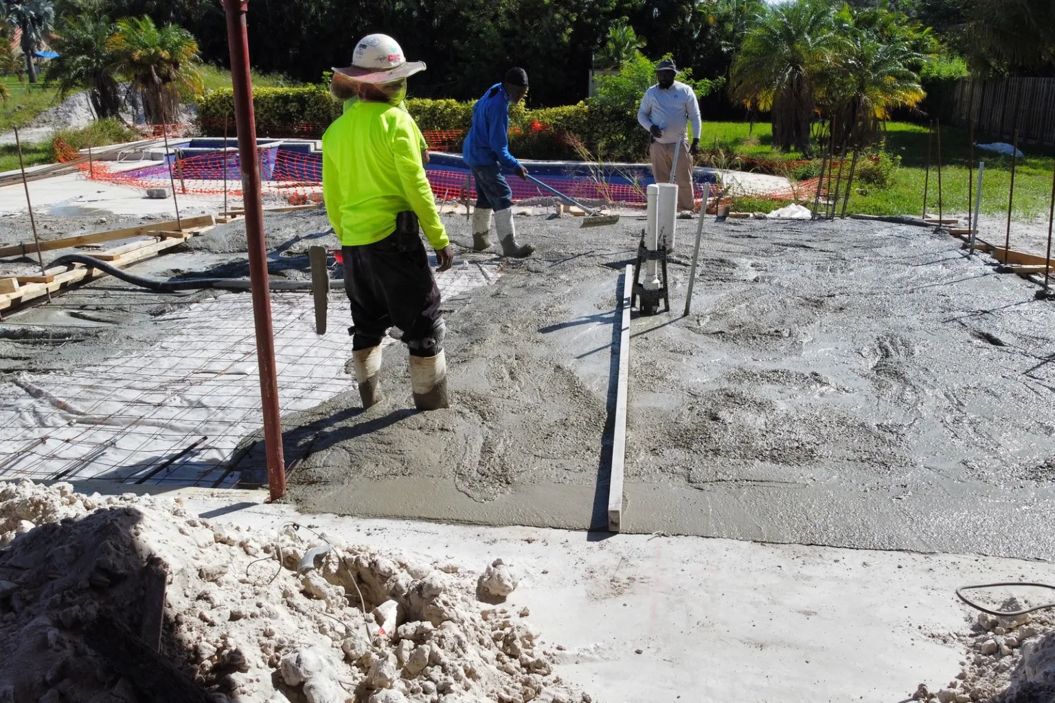 Crew screeding and floating a monolithic slab pour