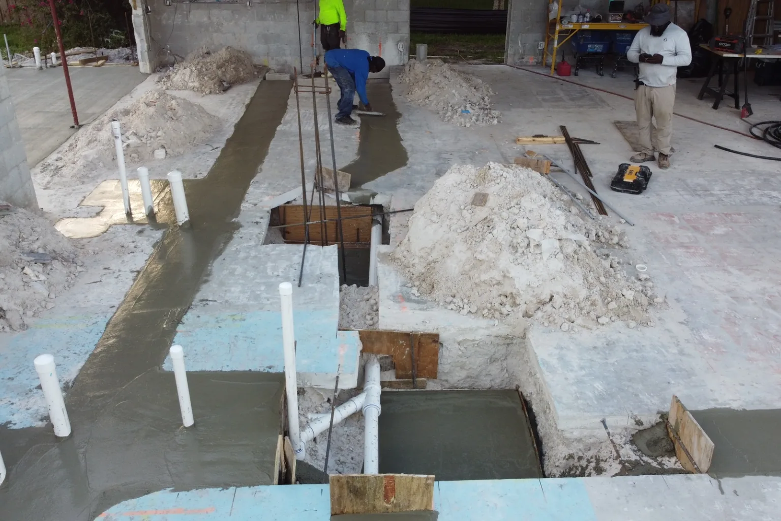 Poured footing trenches with plumbing stub-ups before the slab