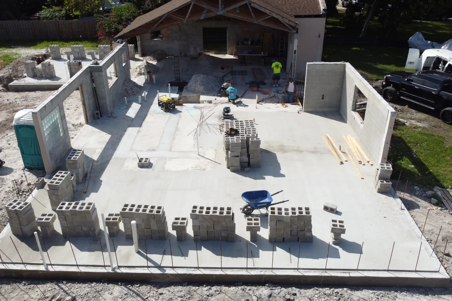 Aerial view of a poured addition slab with block staged and dowels standing